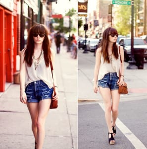 High waisted shorts with a tucked in blouse places emphasis on the hips