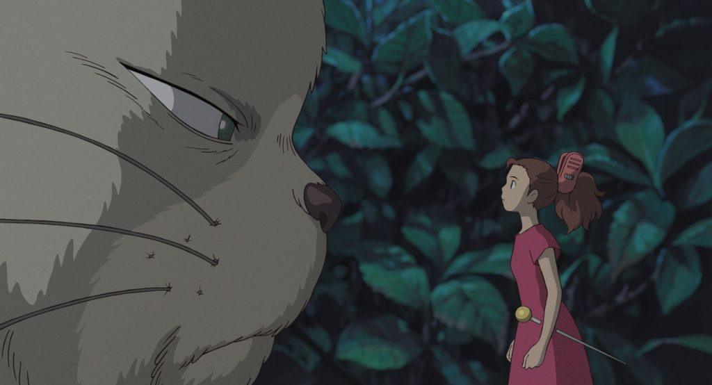 Arrietty faces off with a cat. 