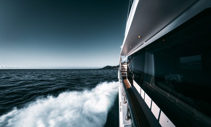 White and black ship on sea under blue sky during daytime